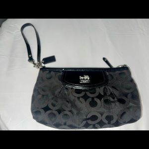 Black Coach Clutch in very good condition with tons of life.